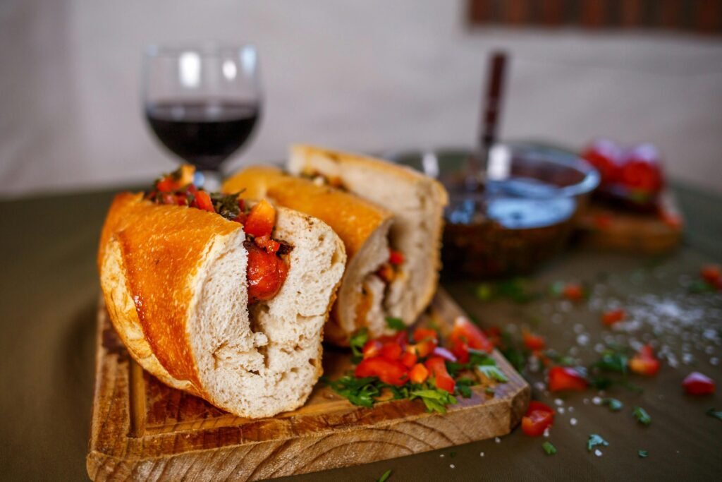 Close-up of a tasty choripán sandwich served with wine, highlighting Argentinian flavors.